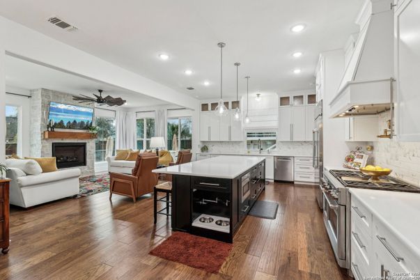 Fireplace, Interior, Kitchen, Living room, Pendant Lights, Recessed Lighting, Stainless Steel Appliances, Stone Walls, Wood Texture Flooring