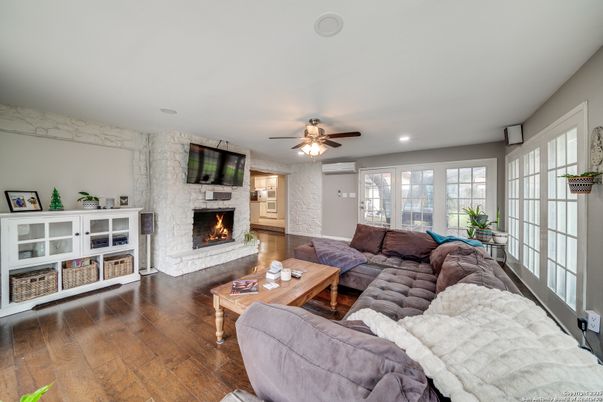 Fireplace, Interior, Living room, Recessed Lighting, Stone Walls, Wood Texture Flooring