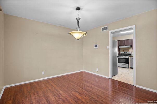 Empty room, Interior, Kitchen, Pendant Lights, Stainless Steel Appliances, Wood Texture Flooring