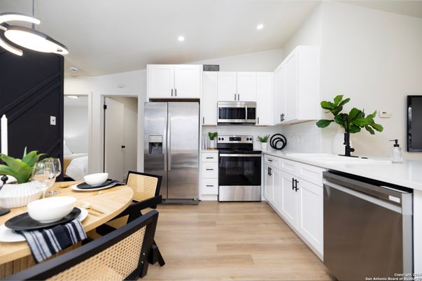 Dining room, Interior, Kitchen, Pendant Lights, Recessed Lighting, Stainless Steel Appliances, Wood Texture Flooring