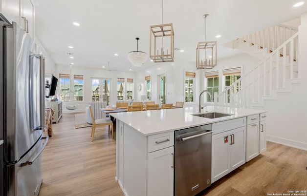 Chandelier, Dining room, Interior, Kitchen, Pendant Lights, Recessed Lighting, Stainless Steel Appliances, Wood Texture Flooring