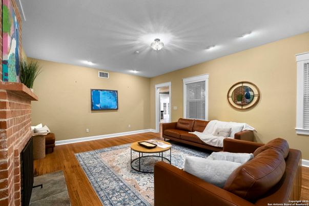 Fireplace, Interior, Living room, Recessed Lighting, Stone Walls, Wood Texture Flooring