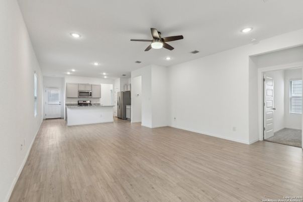 Empty room, Interior, Kitchen, Recessed Lighting, Stainless Steel Appliances, Wood Texture Flooring