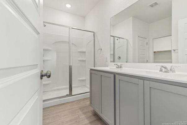 Bathroom, Dual Sink Vanities, Glass Shower, Interior, Recessed Lighting, Wood Texture Flooring