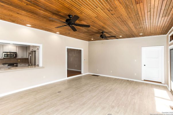 Empty room, Interior, Kitchen, Recessed Lighting, Stainless Steel Appliances, Wooden Ceilings, Wood Texture Flooring