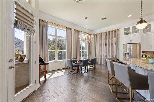 Chandelier, Dining room, Interior, Kitchen, Pendant Lights, Recessed Lighting, Stainless Steel Appliances, Wood Texture Flooring
