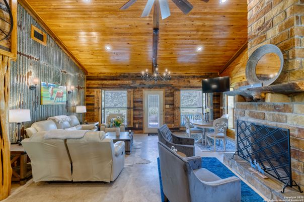 Chandelier, Dining room, Fireplace, Interior, Living room, Recessed Lighting, Stone Walls, Wooden Beams, Wooden Ceilings, Wooden Walls