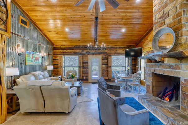 Chandelier, Dining room, Fireplace, Interior, Living room, Recessed Lighting, Stone Walls, Wooden Beams, Wooden Ceilings, Wooden Walls