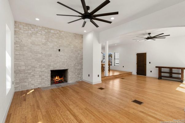 Empty room, Fireplace, Interior, Recessed Lighting, Stone Walls, Wood Texture Flooring