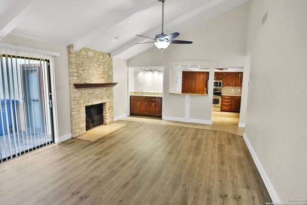 Empty room, Fireplace, Interior, Kitchen, Recessed Lighting, Stone Walls, Wood Texture Flooring