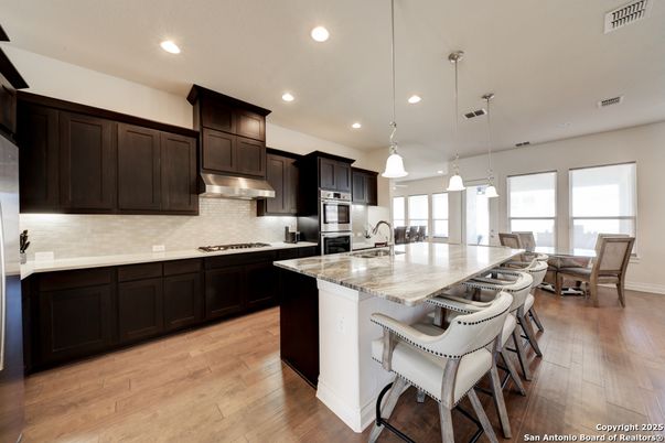 Dining room, Interior, Kitchen, Pendant Lights, Recessed Lighting, Stainless Steel Appliances, Wood Texture Flooring