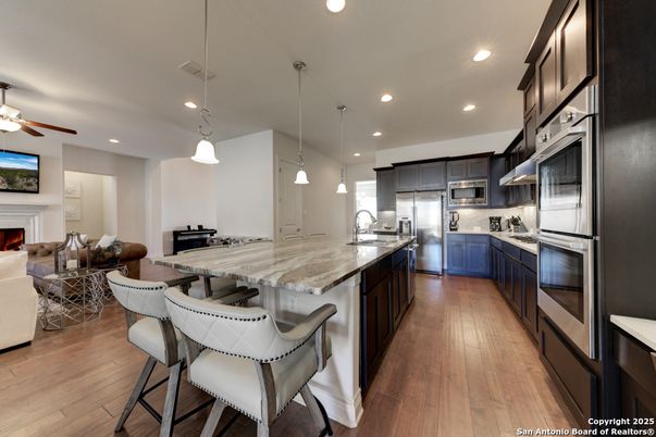 Fireplace, Interior, Kitchen, Pendant Lights, Recessed Lighting, Stainless Steel Appliances, Wood Texture Flooring