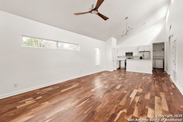 Empty room, Interior, Kitchen, Pendant Lights, Stainless Steel Appliances, Wood Texture Flooring