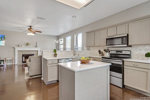 Fireplace, Interior, Kitchen, Recessed Lighting, Stainless Steel Appliances, Wood Texture Flooring