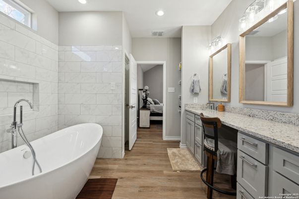 Bathroom, Bedroom, Dual Sink Vanities, Free Standing Baths, Interior, Marble Walls, Recessed Lighting, Wood Texture Flooring