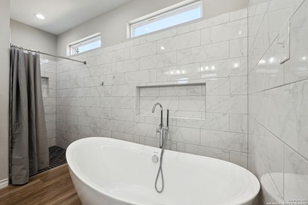 Bathroom, Free Standing Baths, Interior, Marble Walls, Recessed Lighting, Wood Texture Flooring