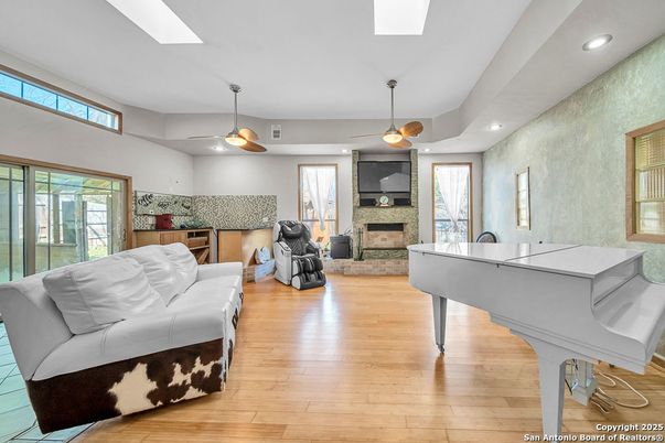 Fireplace, Interior, Living room, Piano, Recessed Lighting, Wood Texture Flooring