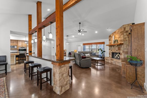 Fireplace, Interior, Kitchen, Living room, Pendant Lights, Recessed Lighting, Stainless Steel Appliances, Stone Walls