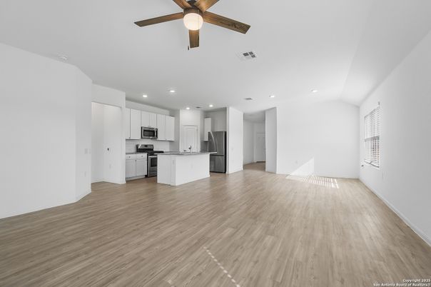 Empty room, Interior, Kitchen, Recessed Lighting, Stainless Steel Appliances, Wood Texture Flooring