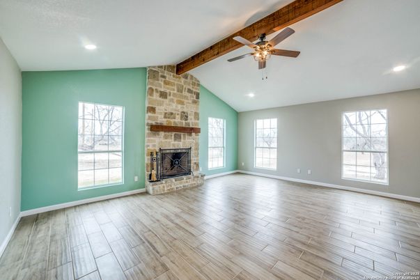 Empty room, Fireplace, Interior, Recessed Lighting, Stone Walls, Wooden Beams, Wood Texture Flooring