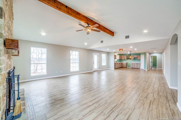 Empty room, Fireplace, Interior, Kitchen, Pendant Lights, Recessed Lighting, Wooden Beams, Wood Texture Flooring