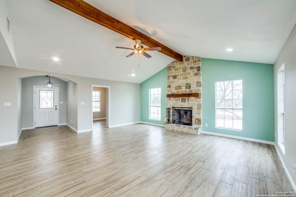 Empty room, Fireplace, Interior, Recessed Lighting, Stone Walls, Wooden Beams, Wood Texture Flooring
