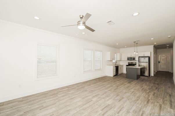 Empty room, Interior, Kitchen, Pendant Lights, Recessed Lighting, Stainless Steel Appliances, Wood Texture Flooring