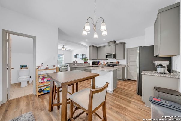 Chandelier, Dining room, Interior, Kitchen, Stainless Steel Appliances, Wood Texture Flooring