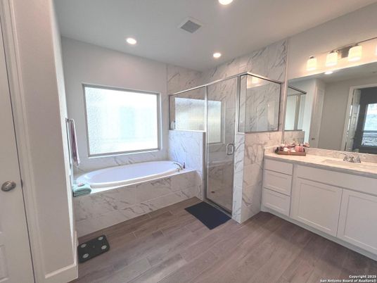 Bathroom, Dual Sink Vanities, Glass Shower, Interior, Marble Walls, Recessed Lighting, Wood Texture Flooring