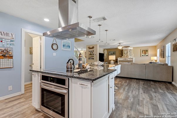 Dining room, Fireplace, Interior, Kitchen, Living room, Pendant Lights, Recessed Lighting, Stainless Steel Appliances, Wood Texture Flooring
