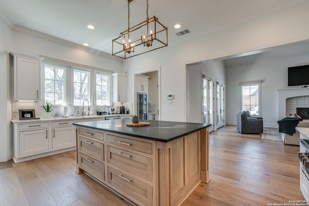 Chandelier, Fireplace, Interior, Kitchen, Living room, Pendant Lights, Recessed Lighting, Wood Texture Flooring
