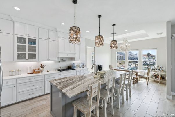Chandelier, Dining room, Interior, Kitchen, Pendant Lights, Recessed Lighting, Stainless Steel Appliances, Wood Texture Flooring