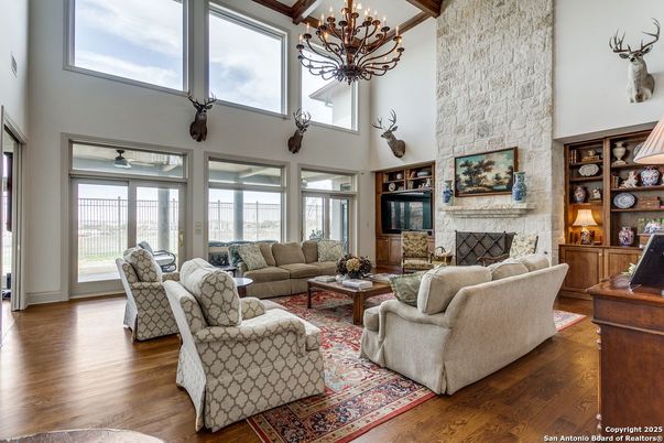 Chandelier, Fireplace, Interior, Living room, Stone Walls, Wooden Beams, Wood Texture Flooring