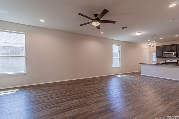 Empty room, Interior, Kitchen, Recessed Lighting, Stainless Steel Appliances, Wood Texture Flooring
