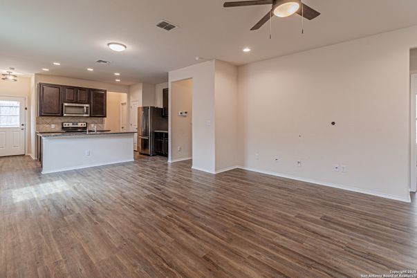 Empty room, Interior, Kitchen, Recessed Lighting, Stainless Steel Appliances, Wood Texture Flooring