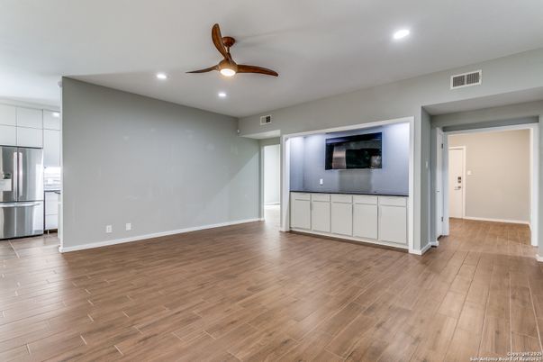 Empty room, Interior, Kitchen, Recessed Lighting, Stainless Steel Appliances, Wood Texture Flooring