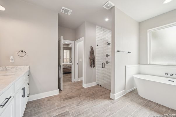 Bathroom, Free Standing Baths, Glass Shower, Interior, Recessed Lighting, Wood Texture Flooring