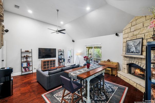 Dining room, Fireplace, Interior, Living room, Recessed Lighting, Stone Walls, Wood Texture Flooring