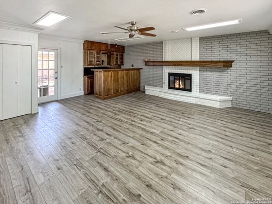 Empty room, Fireplace, Interior, Kitchen, Recessed Lighting, Stone Walls, Wood Texture Flooring