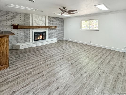 Empty room, Fireplace, Interior, Recessed Lighting, Stone Walls, Wood Texture Flooring
