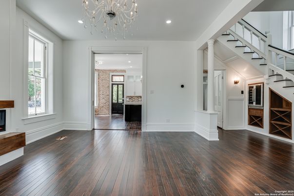 Chandelier, Empty room, Fireplace, Interior, Recessed Lighting, Wood Texture Flooring