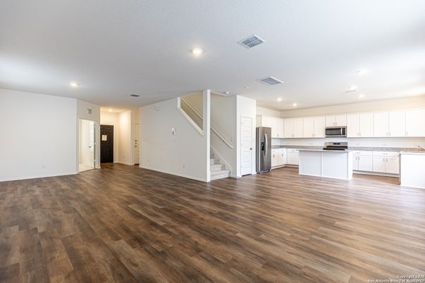 Empty room, Interior, Kitchen, Recessed Lighting, Stainless Steel Appliances, Wood Texture Flooring