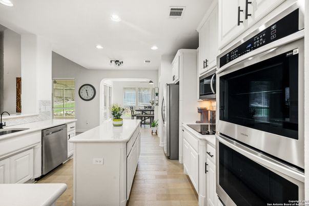 Dining room, Interior, Kitchen, Recessed Lighting, Stainless Steel Appliances, Wood Texture Flooring