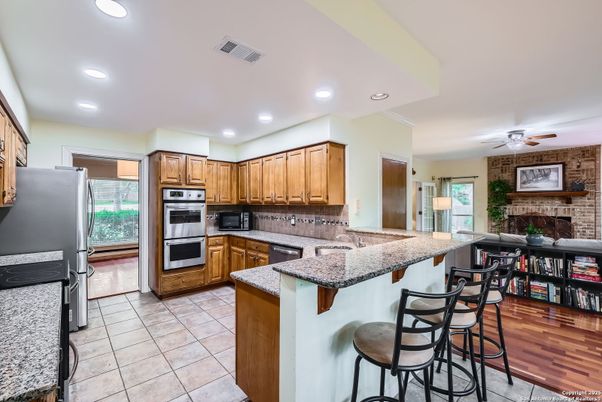 Fireplace, Interior, Kitchen, Recessed Lighting, Stone Walls, Wood Texture Flooring