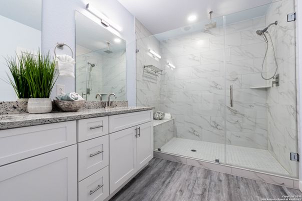 Bathroom, Dual Sink Vanities, Glass Shower, Interior, Marble Walls, Recessed Lighting, Wood Texture Flooring
