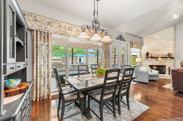 Chandelier, Dining room, Fireplace, Interior, Living room, Stone Walls, Wood Texture Flooring