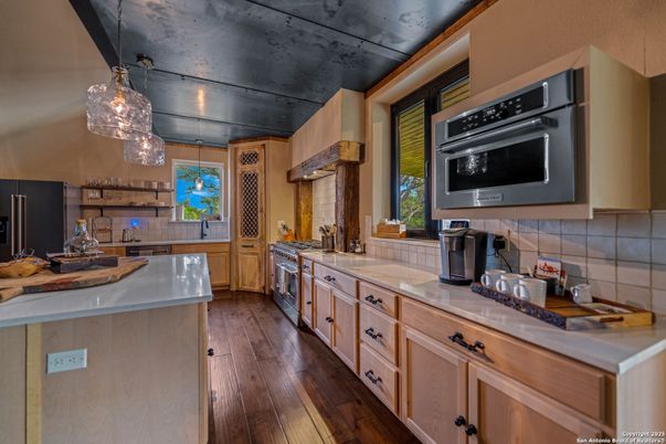 Interior, Kitchen, Pendant Lights, Stainless Steel Appliances, Tile Countertops, Wood Texture Flooring