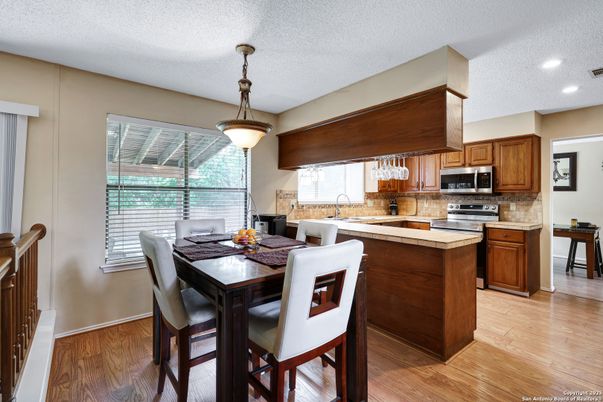 Dining room, Interior, Kitchen, Pendant Lights, Recessed Lighting, Stainless Steel Appliances, Wood Texture Flooring