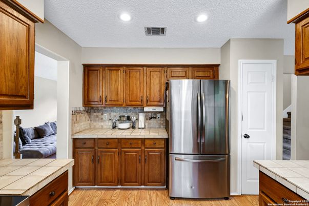 Interior, Kitchen, Recessed Lighting, Stainless Steel Appliances, Tile Countertops, Wood Texture Flooring