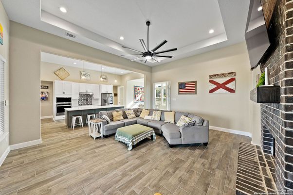 Fireplace, Interior, Kitchen, Living room, Pendant Lights, Recessed Lighting, Stainless Steel Appliances, Stone Walls, Wood Texture Flooring